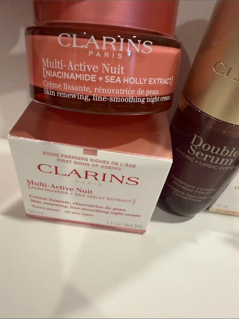 Clarins skincare set in pink, gold, white, and bronze
